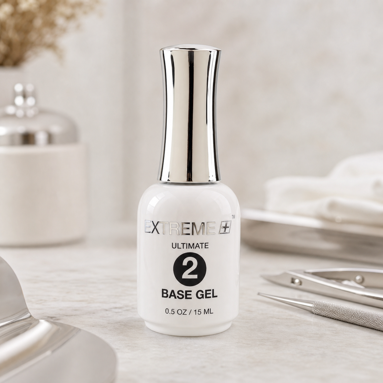 EXTREME+ ULTIMATE Step 2 Base Gel 0.5 oz bottle on a professional nail salon workstation